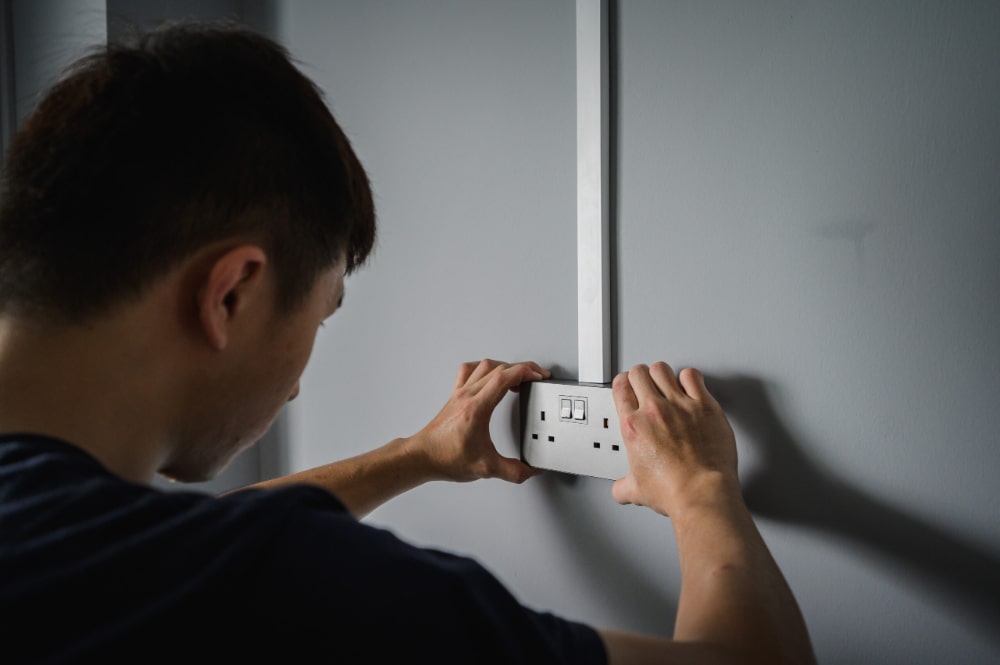 man installing electrical point